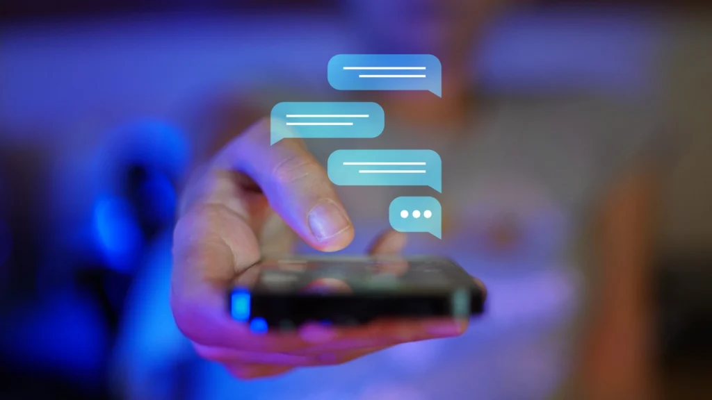 a hand with a phone and chat bubbles